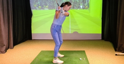 girl in golf simulator.jpg